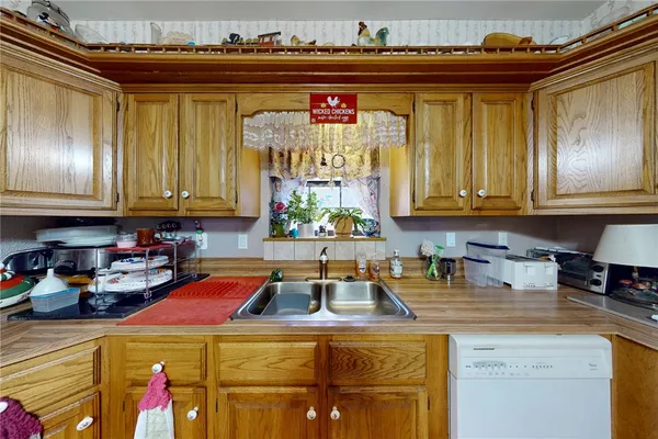 a kitchen with stainless steel appliances granite countertop a sink and cabinets