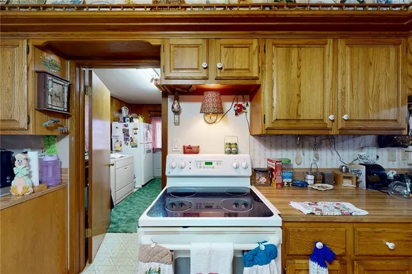 a kitchen with stainless steel appliances granite countertop a stove and cabinets