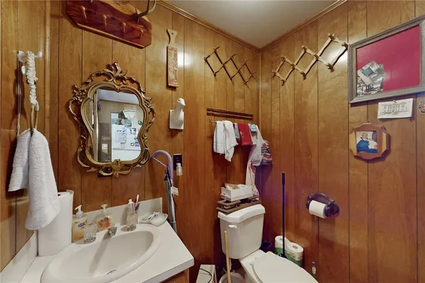 a bathroom with a sink mirror vanity and toilet