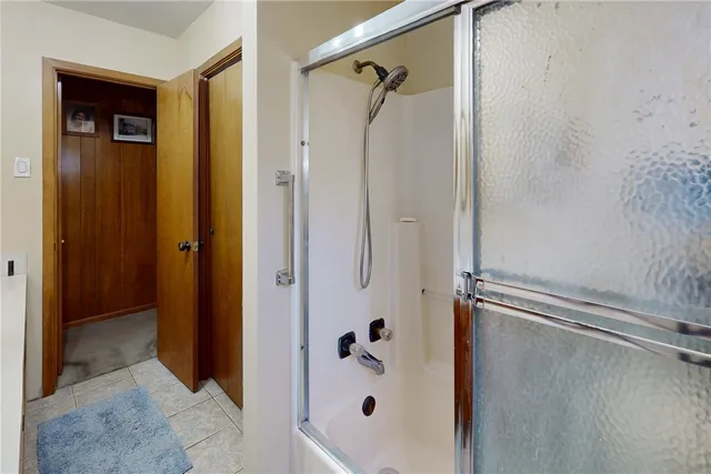 a bathroom with a glass shower door