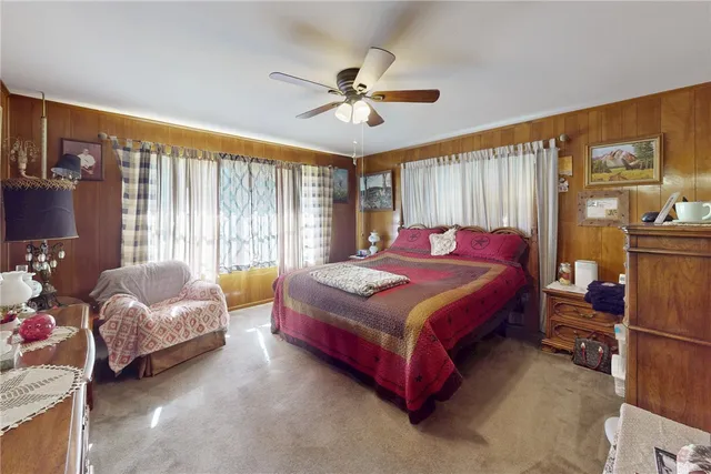 a bedroom with a bed dresser and window