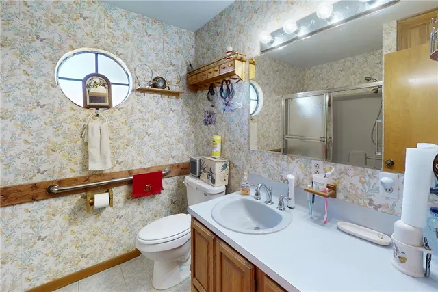 a bathroom with a toilet sink and mirror