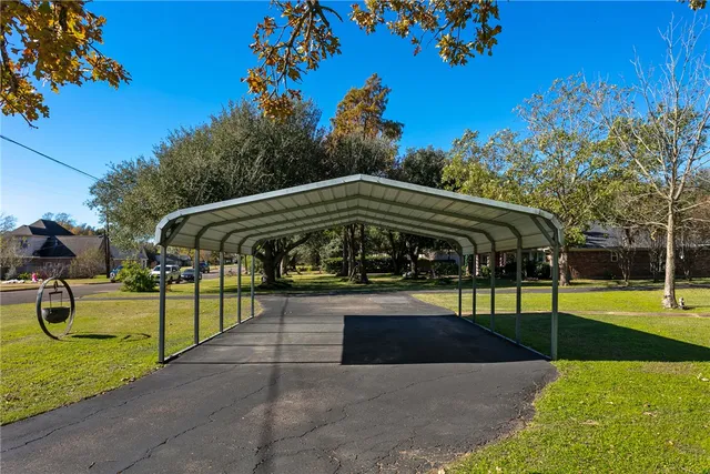 a view of a swimming pool with a lounge chair and grass