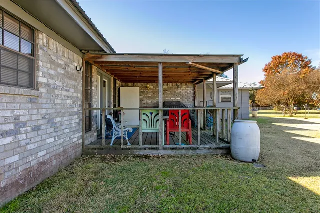 a view of a porch with a floor to ceiling window and stairs