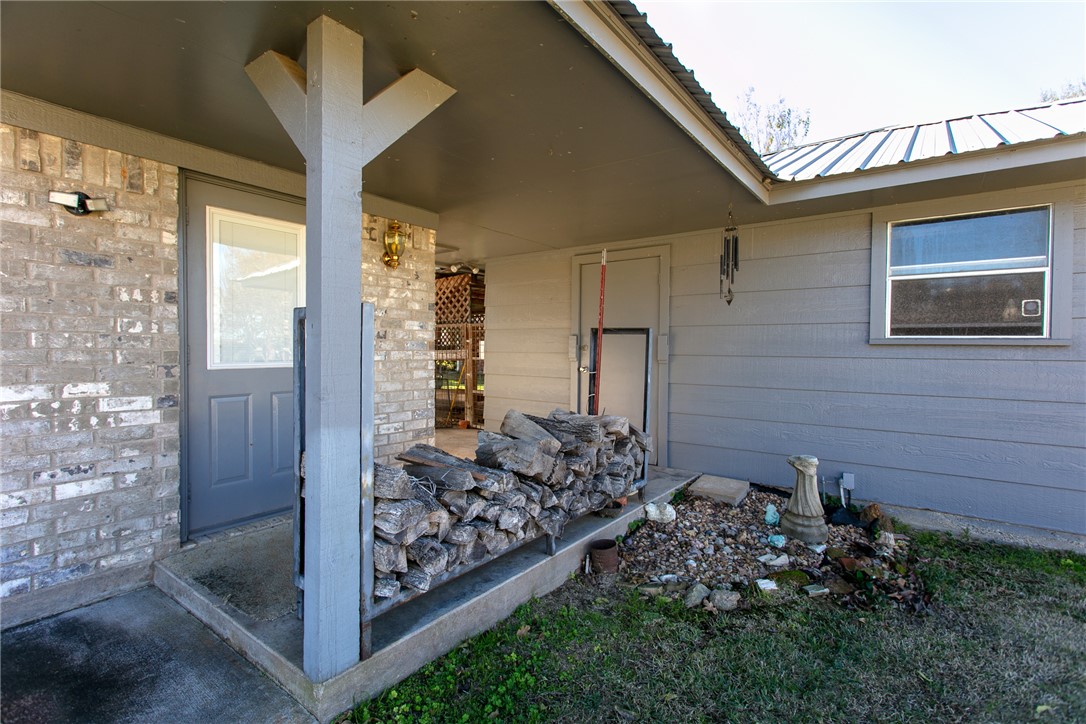 409 Morgan Street Franklin, TX 77856 - Photo 26 of 40 a view of a porch with a floor to ceiling window and stairs
