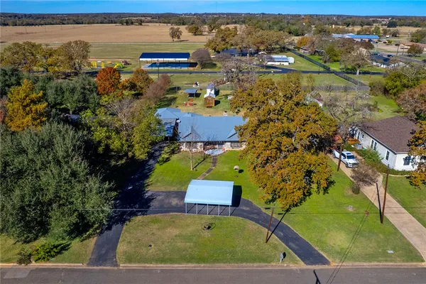 an aerial view of a house with a yard swimming pool