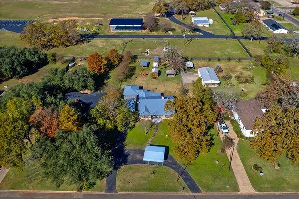 an aerial view of multiple houses with yard