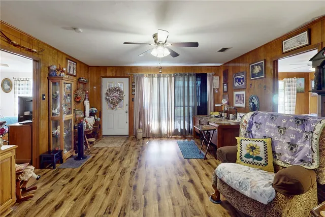a living room with furniture and wooden floor