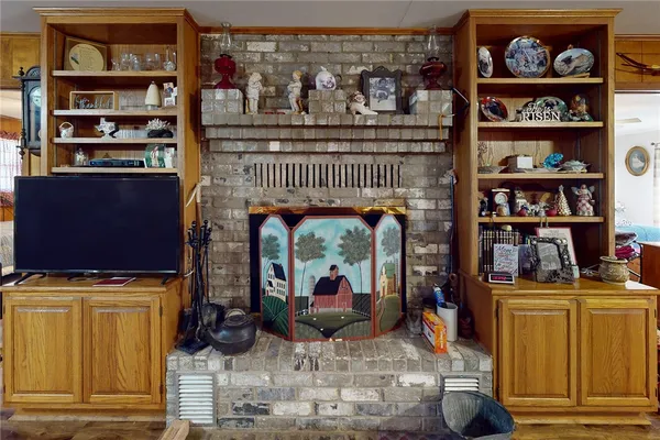 a living room with furniture a rug and a bookshelf