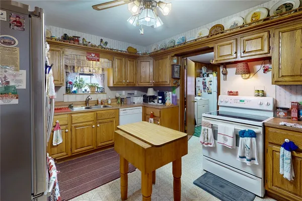 a kitchen with cabinets and wooden floor