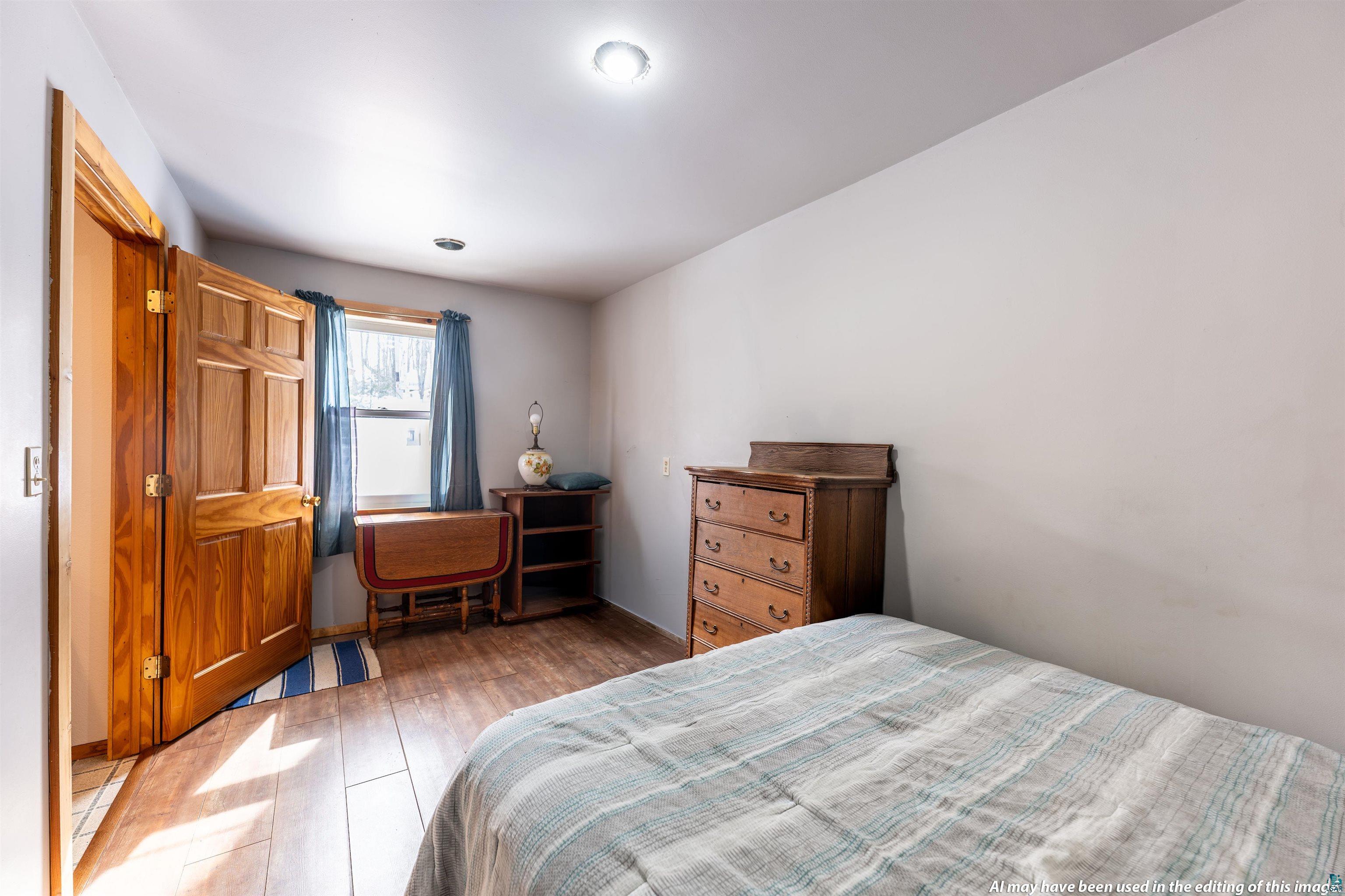 6030 Lake Ahmeek Road Hughes, WI 54847 - Photo 14 of 26 Bedroom featuring wood finished floors