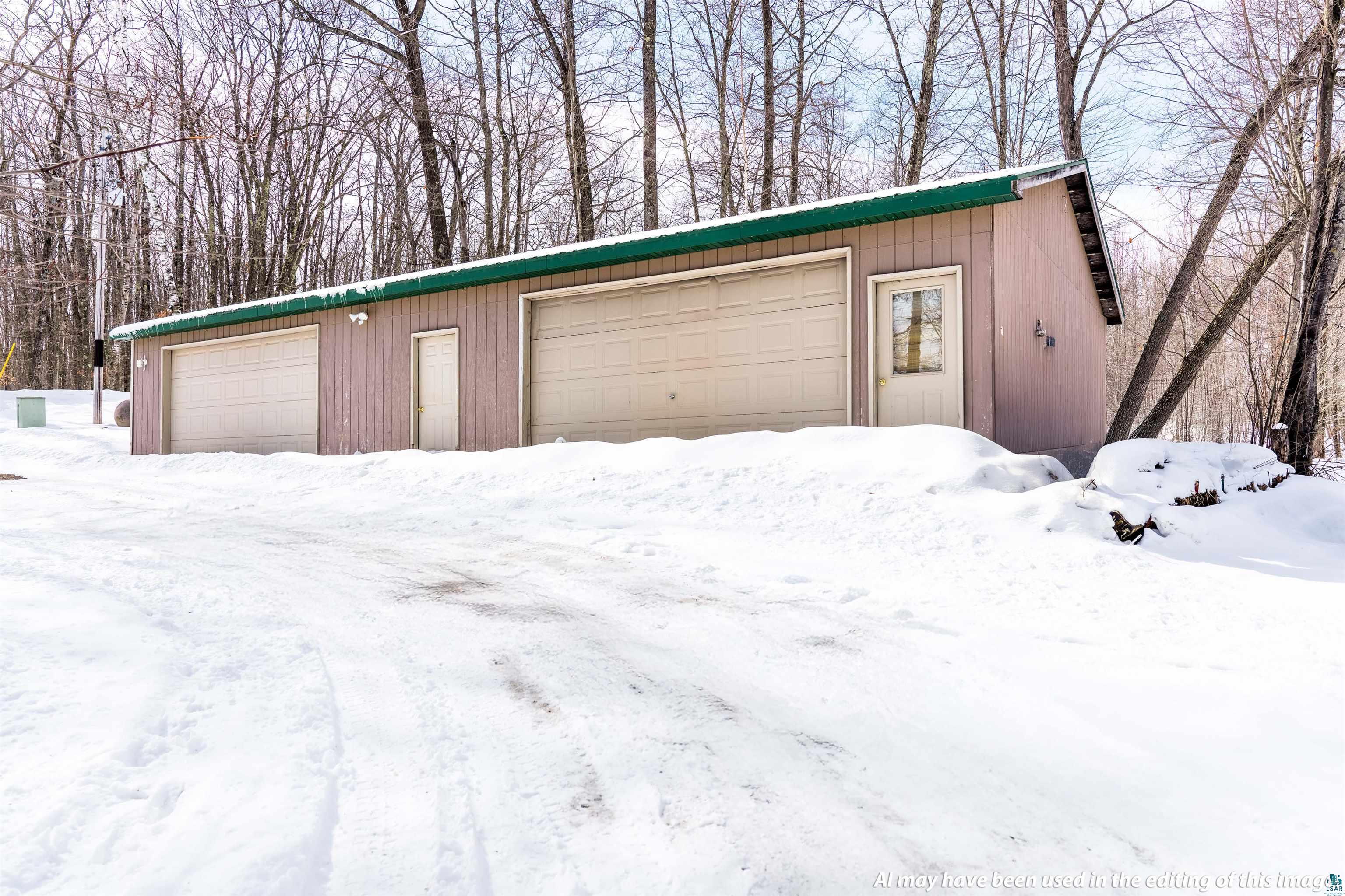 6030 Lake Ahmeek Road Hughes, WI 54847 - Photo 15 of 24 Snow covered garage featuring a detached garage