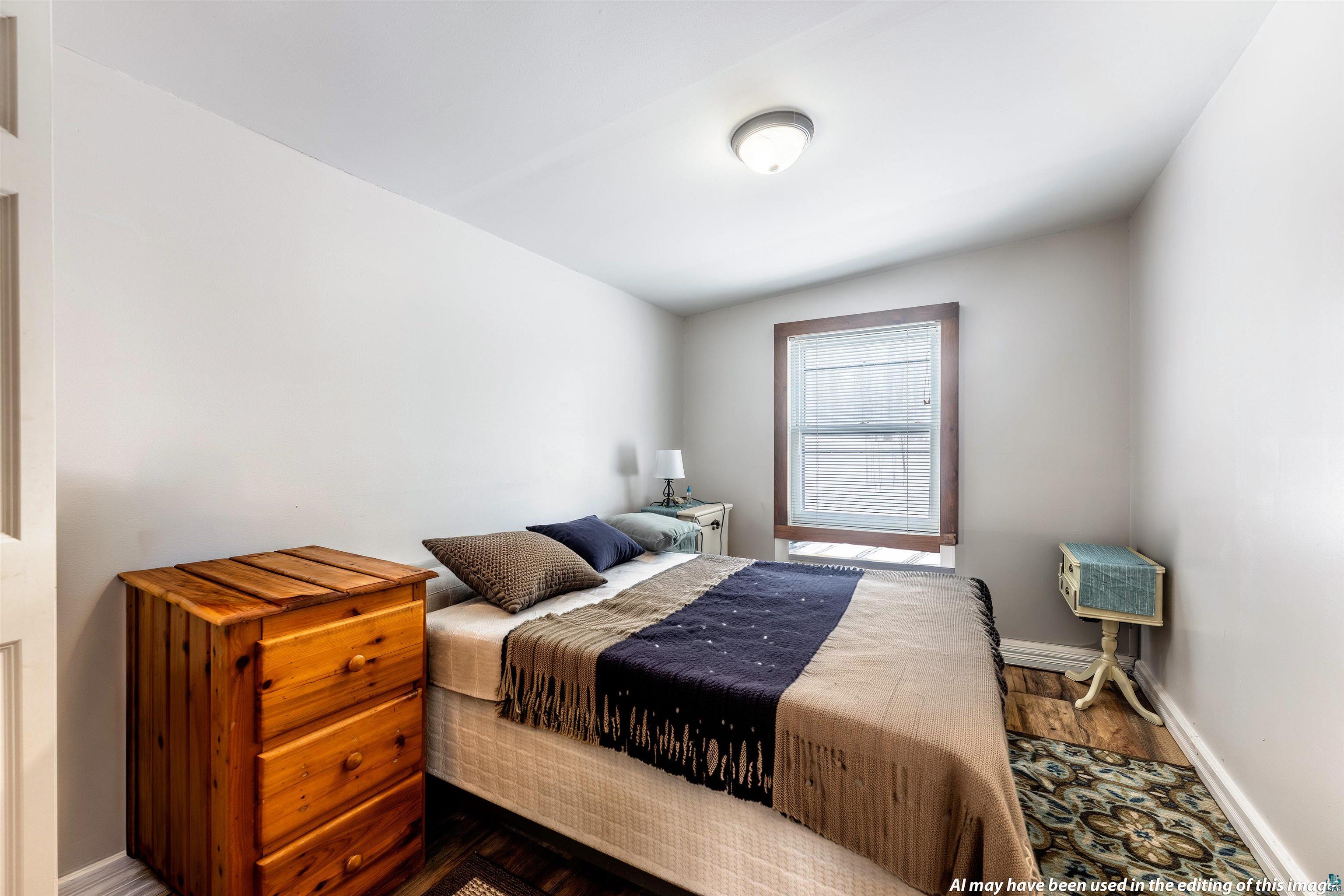 6030 Lake Ahmeek Road Hughes, WI 54847 - Photo 22 of 26 Bedroom featuring baseboards and wood finished floors