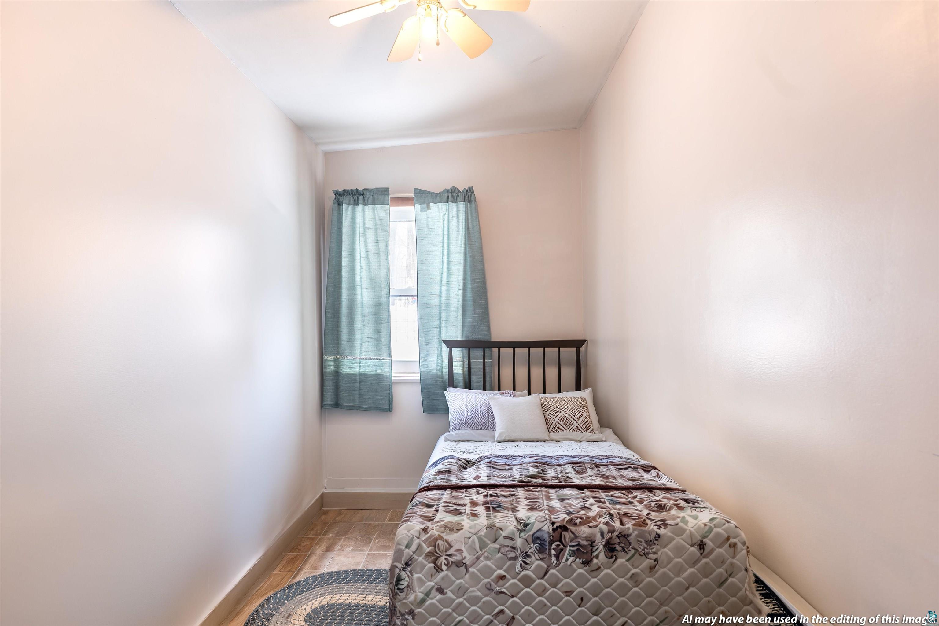 6030 Lake Ahmeek Road Hughes, WI 54847 - Photo 23 of 26 Bedroom with ceiling fan and light wood-type flooring