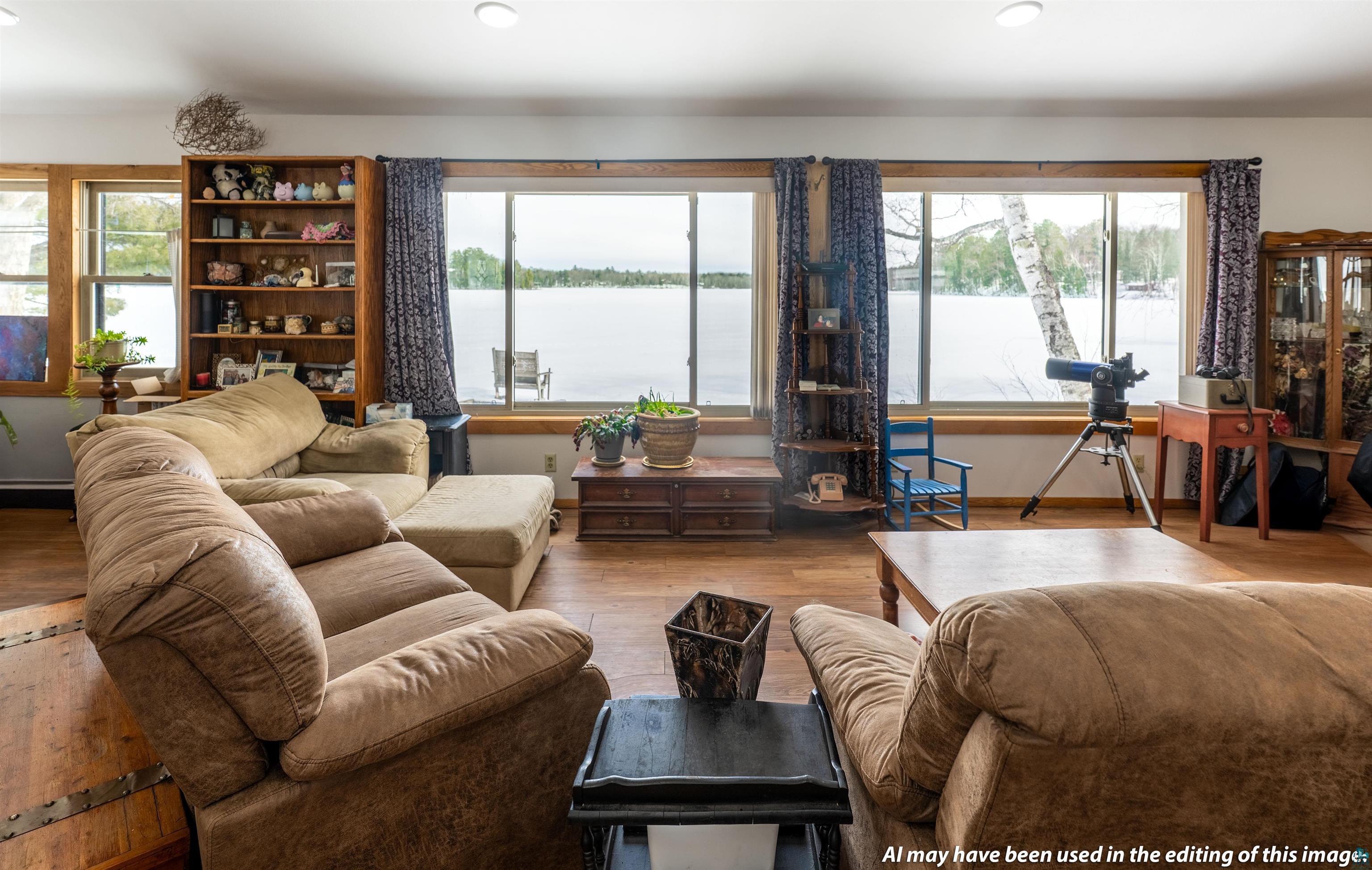 6030 Lake Ahmeek Road Hughes, WI 54847 - Photo 6 of 26 Living area featuring hardwood / wood-style floors, a water view, plenty of natural light, and recessed lighting