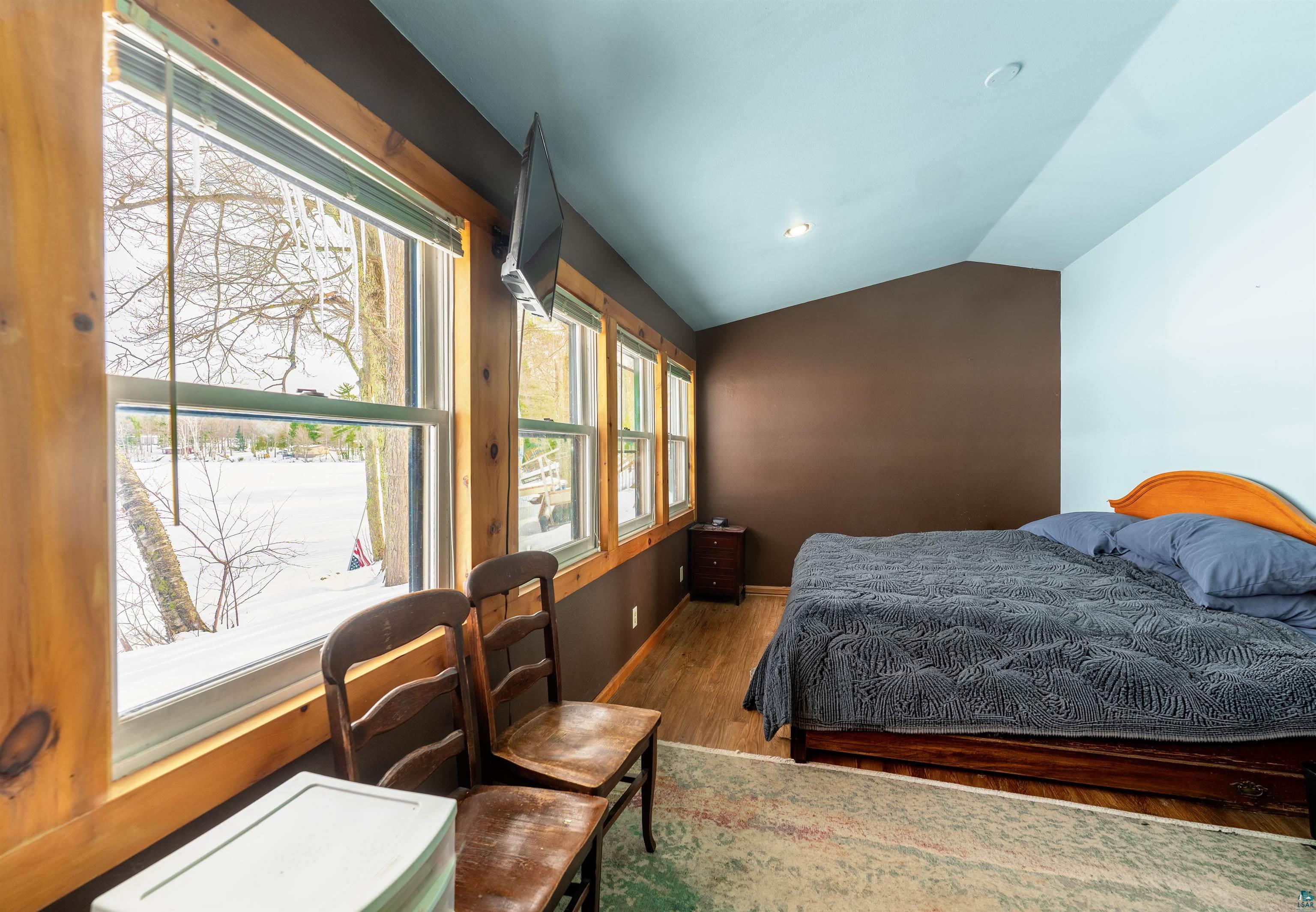 6030 Lake Ahmeek Road Hughes, WI 54847 - Photo 10 of 24 Bedroom with lofted ceiling, wood finished floors, and recessed lighting