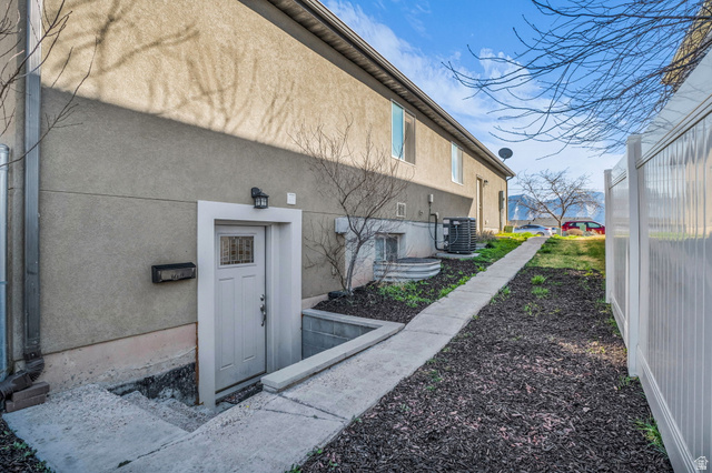 1836 West 800 North Mapleton, UT 84663 - Photo 19 of 38 View of property exterior featuring stucco siding and a central AC unit