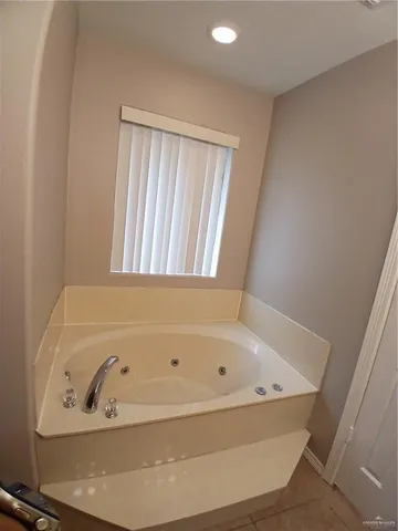 a white toilet sitting next to a white sink and vanity