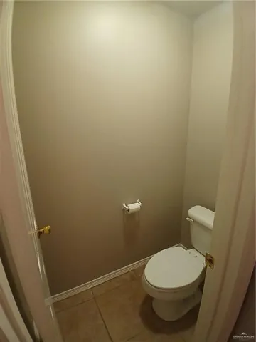 a bathroom with a sink vanity granite and toilet