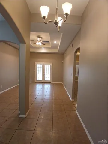 an empty room with mirror and entrance