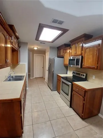 a kitchen with stainless steel appliances granite countertop a sink and cabinets