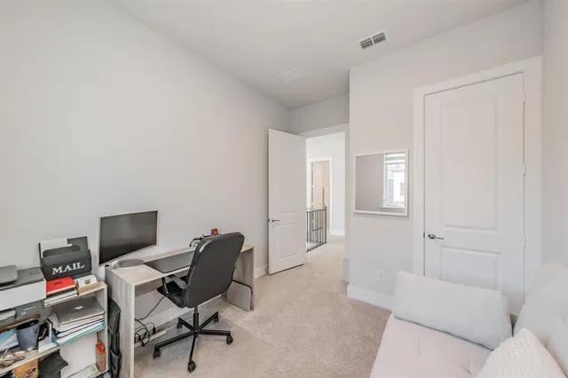 a spacious bedroom with a bed and glass door