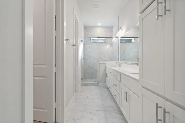 a bathroom with a double vanity sink and a shower