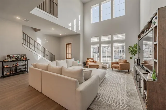 a living room with furniture and a view of kitchen