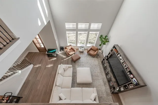 a kitchen that has a lot of white cabinets and wooden floor