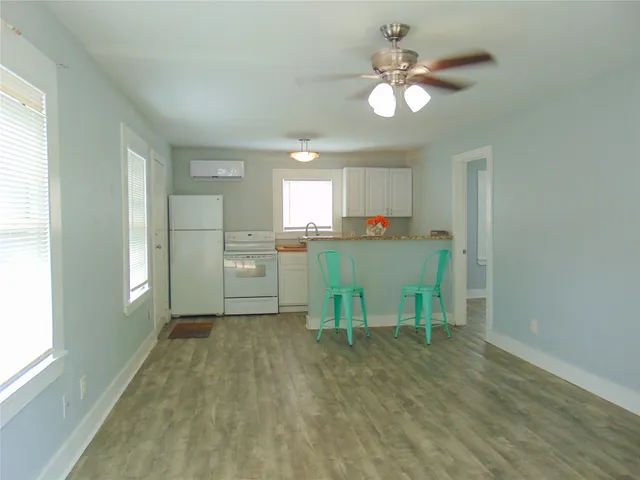a view of a kitchen with a table and chairs
