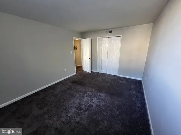 a white toilet sitting next to a bathroom sink and vanity