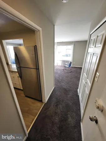 a view of a kitchen from a hallway