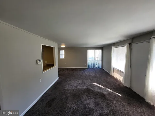 a kitchen with a sink and wooden floor