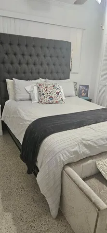 a bedroom with a bed and couch