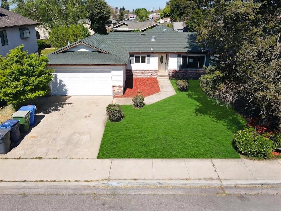 1465 West Tuolumne Road Turlock, CA 95382 - Photo 2 of 7 front view of house with a yard
