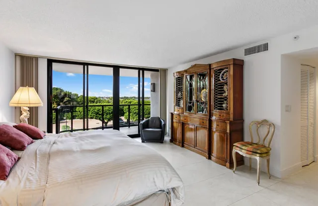 a bedroom with a bed and a large window