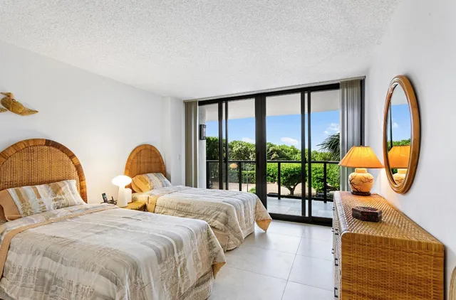 a bedroom with bed and a large window