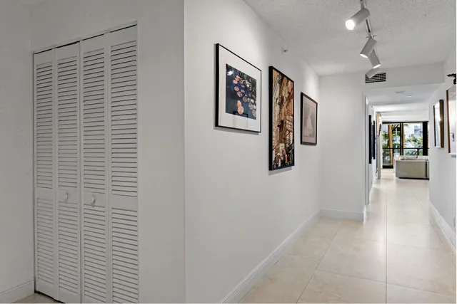 a view of a hallway with wooden floor and windows