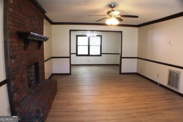 118 Whipoorwill Way Dublin, GA 31021 - Photo 13 of 28 a view of empty room with wooden floor and fan