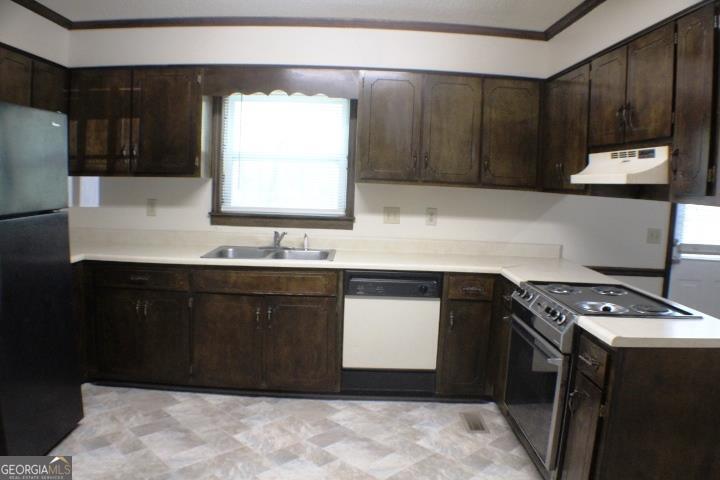 118 Whipoorwill Way Dublin, GA 31021 - Photo 15 of 28 a kitchen with a sink and cabinets