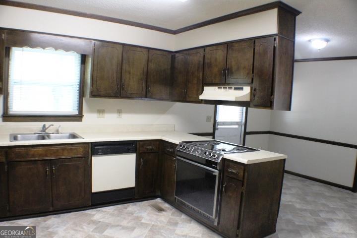 118 Whipoorwill Way Dublin, GA 31021 - Photo 16 of 28 a kitchen with stainless steel appliances granite countertop a stove a sink and a microwave