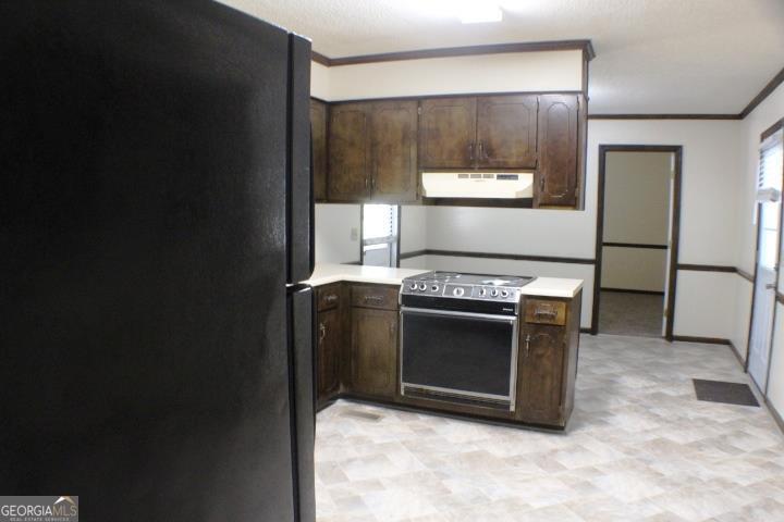 118 Whipoorwill Way Dublin, GA 31021 - Photo 19 of 28 a kitchen with a stove and a refrigerator