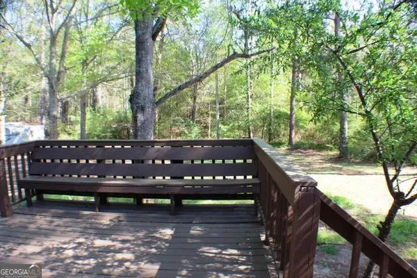 a wooden bench sitting in front of a forest