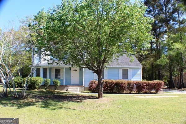 a front view of a house with a yard garage and outdoor seating