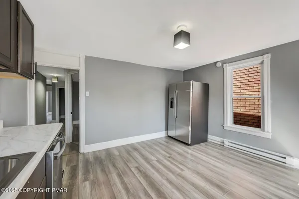 a view of bedroom with wooden floor