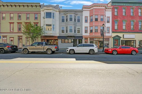 a view of a building with car parked