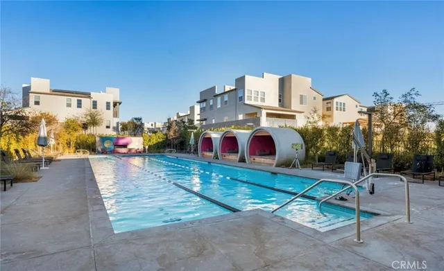 swimming pool view with a outdoor seating space