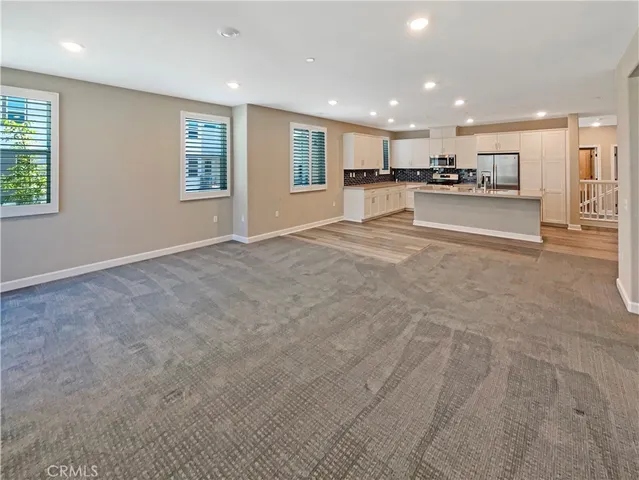 a view of kitchen with sink microwave and cabinets