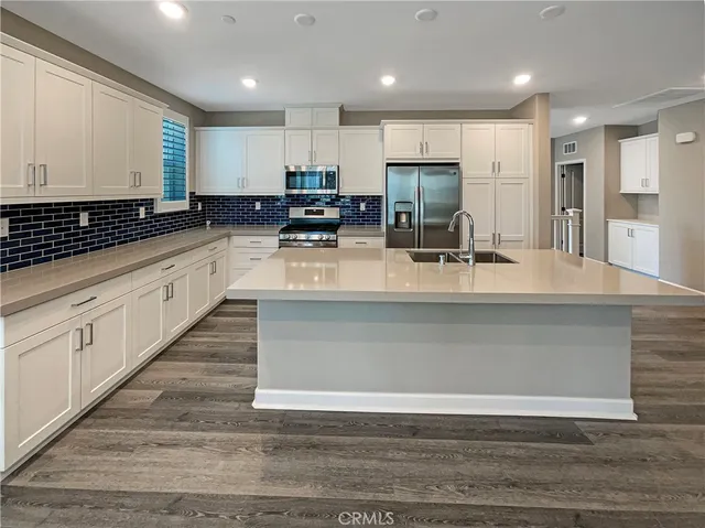 a kitchen with a stove and white cabinets
