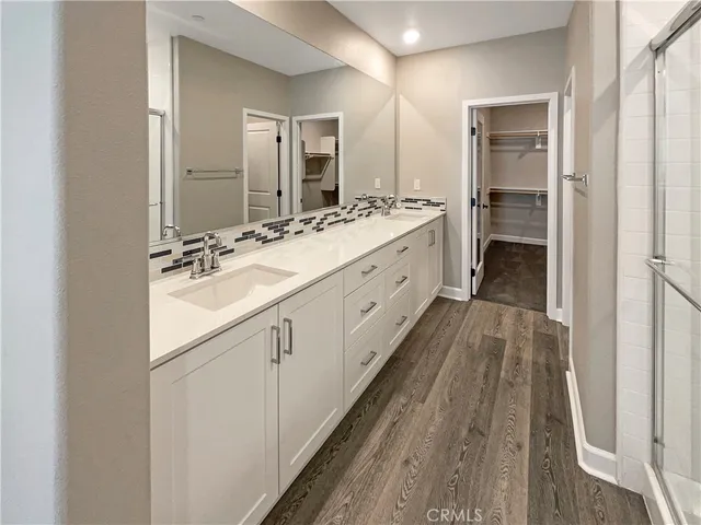 a view of an empty room with closet and a window